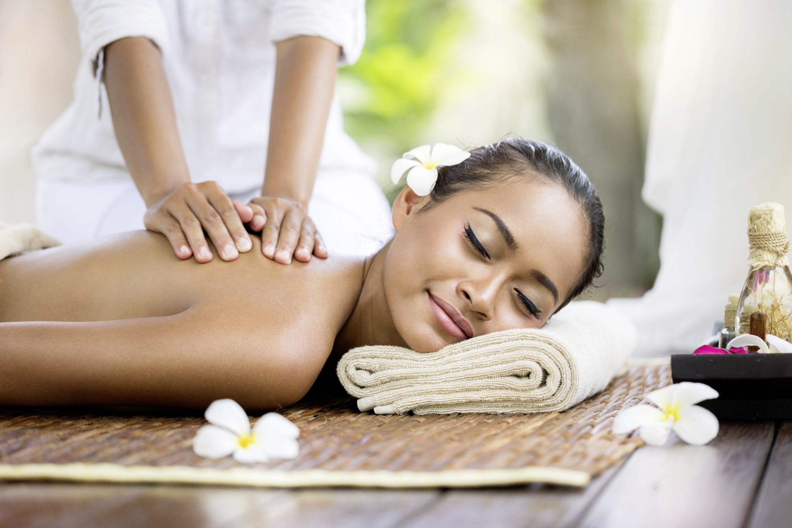 Spa massage outdoor, Balinese woman receiving back massage